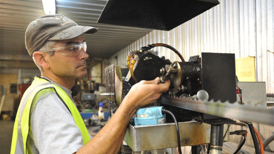 Sawmill operator sharpening blade