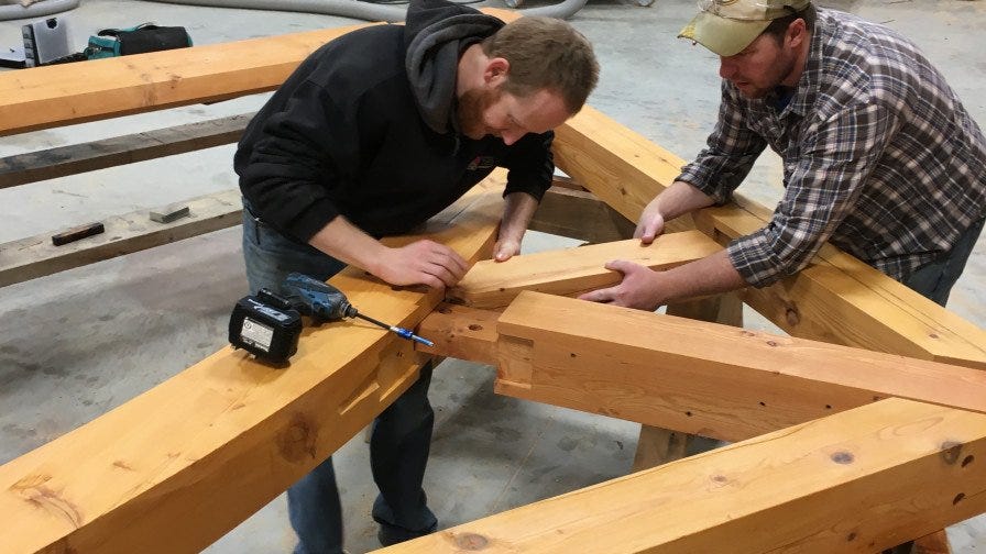 Last Mountain Timber woodworkers building structure